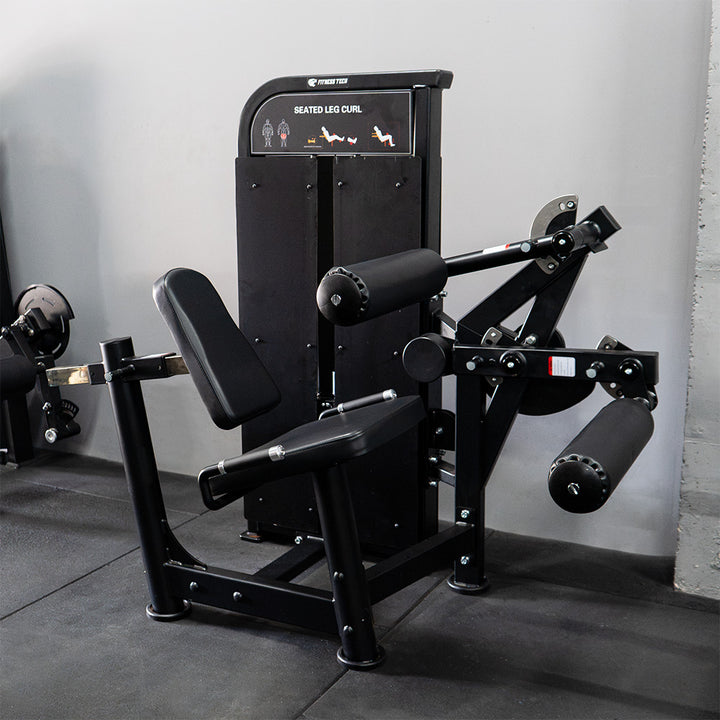 Femoral sentado | Máquina selectorizada - Compact Series lateral